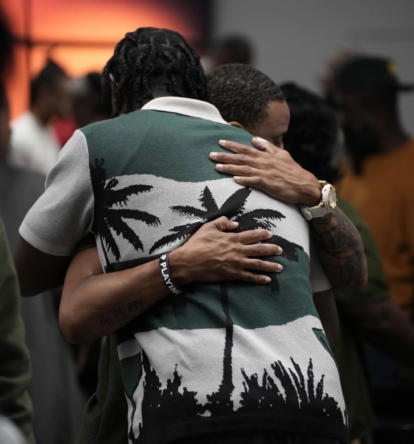 A man welcoming another with a hug at a C4 Sunday Gathering